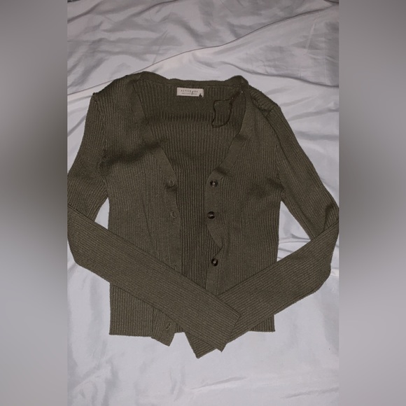 Green cardigan type button up. Its a bit itchy so you should wear a tank under. - Picture 2 of 3